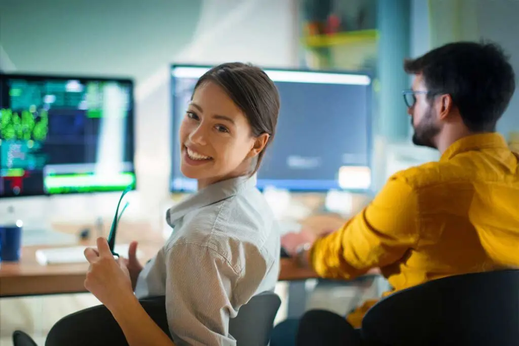 Web Developer smiling at Portfolio plus office