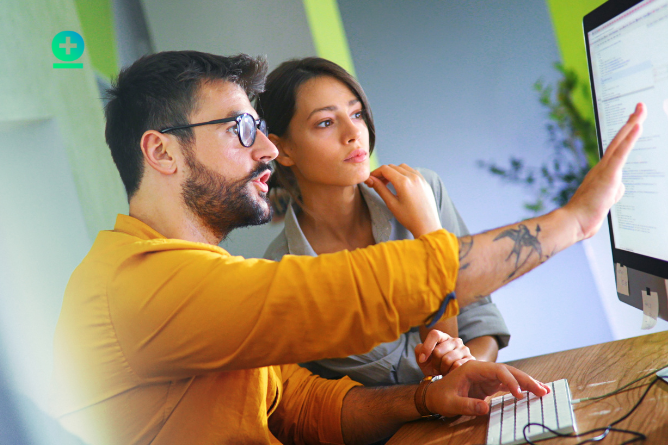 two people working on a loan software on the screen